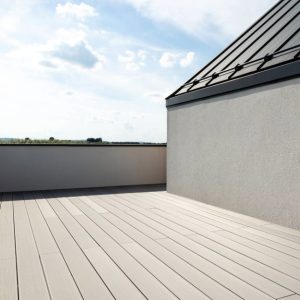 Una terrazza di una lussuosa casa minimale, con pavimento in decking in legno grigio chiaro